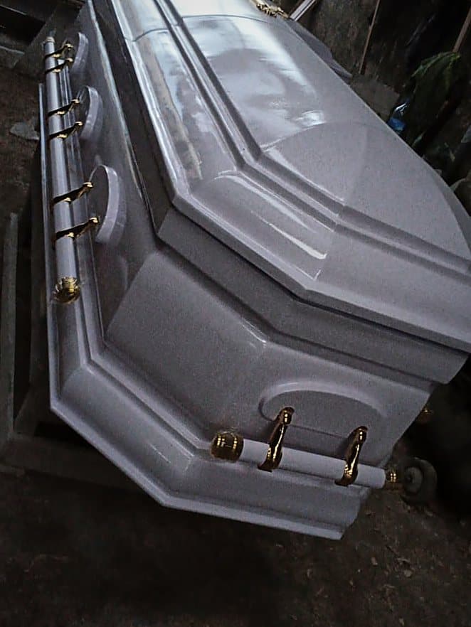 A grey eight-edge semi-dome casket with swing bar handles