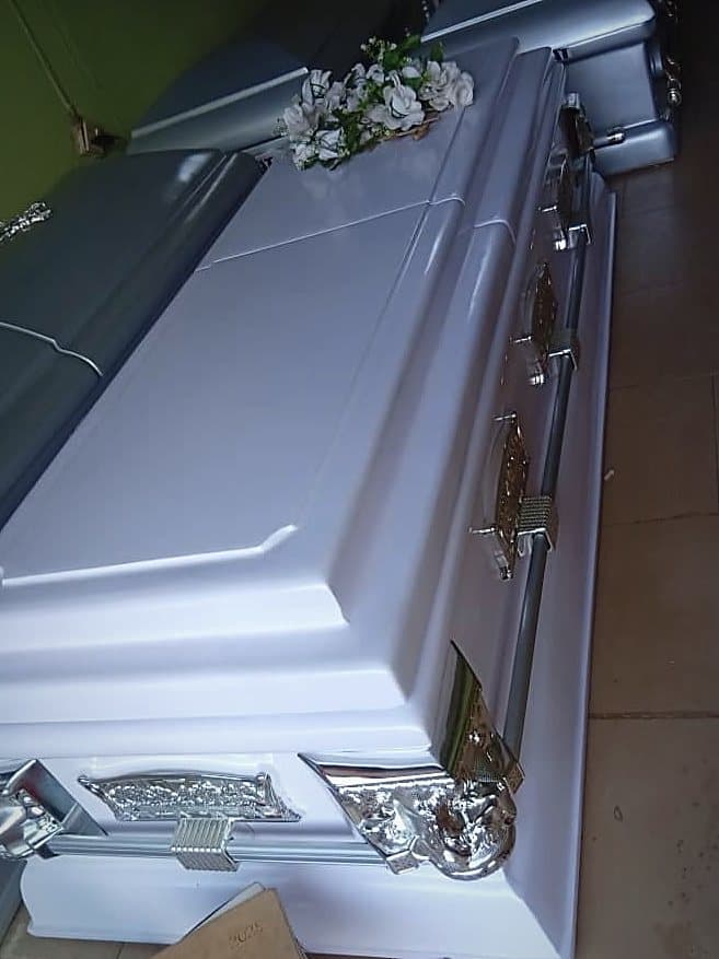 A white Supreme casket with a chrome bar handle and silver corner mounts