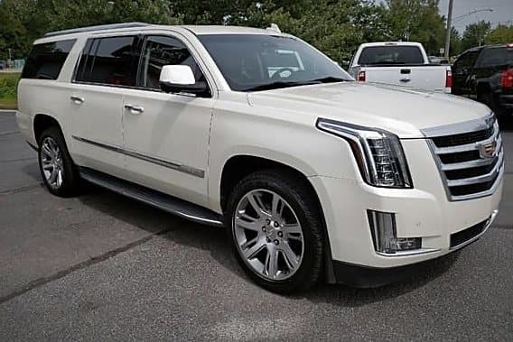 The white Cadillac Escalade in three-quarter front view