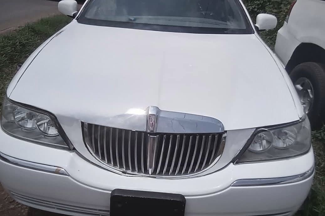 The white stretch limousine, three-quarter front, grille and headlamps